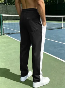 Detail of men's color-block joggers showing the back pocket and white side stripes