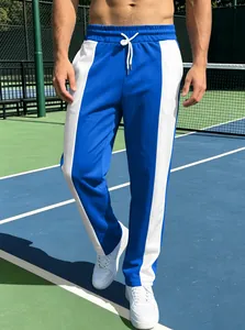 Detail of blue and white contrast paneling on men's athletic jogger pants with drawstring