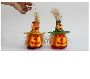 Close-up of Halloween pumpkin scarecrow ornaments with burlap hats and straw details