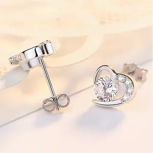 Macro shot of 925 sterling silver heart studs with center cubic zirconia and side accents