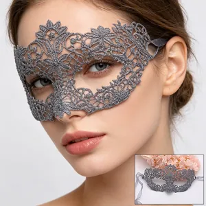 Close-up of silver lace masquerade mask with intricate floral embroidery and silk ribbons