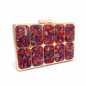 Chic acrylic evening clutch with colorful marble pattern and gold metal frame