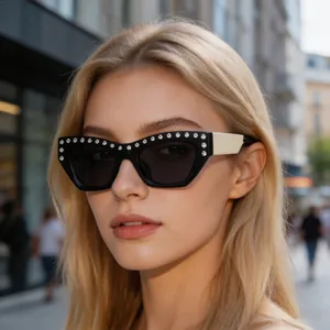 Detail of rhinestone embellishments on vintage cat-eye sunglasses with cream temples