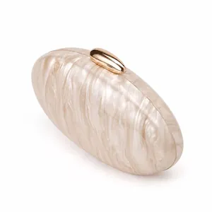 Detailed close-up of marble pattern acrylic evening clutch with gold metal clasp
