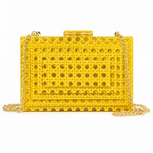 Yellow acrylic evening clutch bag with hollow woven texture and gold chain strap