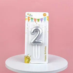 Macro detail of silver number 2 birthday candle in clean blister card packaging