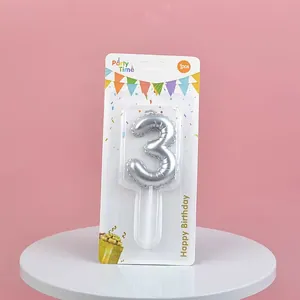 Detail view of silver balloon-style number 3 birthday candle in retail packaging.