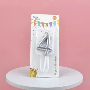 Silver number 4 birthday cake candle displayed in decorative party themed packaging