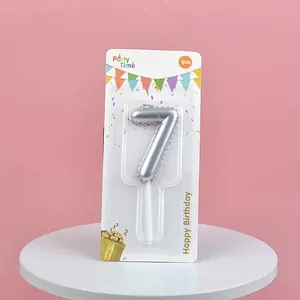 Metallic silver number 7 birthday cake candle presented in a decorative retail card