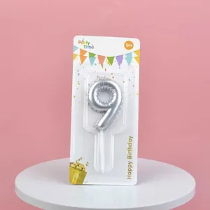 Silver balloon-style number 9 birthday candle in retail packaging