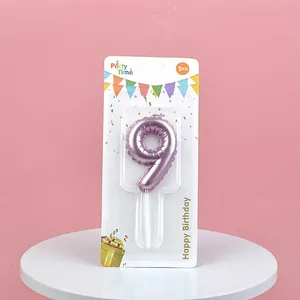 Metallic purple number 9 birthday candle with balloon texture in retail packaging