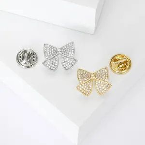 Elegant bow tie brooches in gold and silver finish with sparkling cubic zirconia inlay