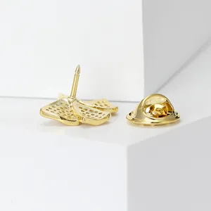 Detailed back view of gold butterfly brooch with secure clutch back on white display