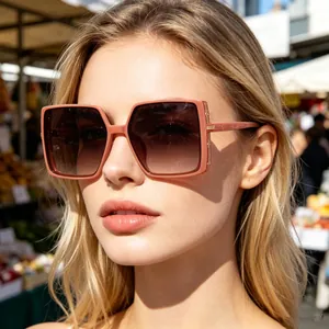 Fashionable oversized square sunglasses with pink frames and gradient lenses on a model