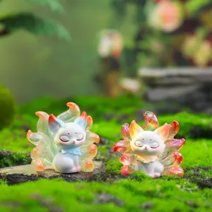 Mythical nine-tailed fox resin figurines in blue and white on natural moss stones