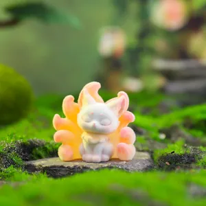 Macro view of white flocked Nine-Tailed Fox figurine with pink gradient tails on moss