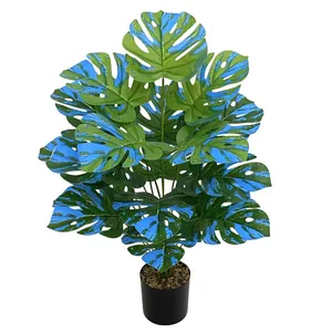 Artificial Monstera plant with unique blue and green variegated leaves in a pot