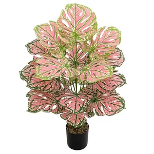 Lifelike artificial Caladium plant with pink and green leaves in a black pot