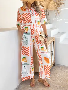 Detail of bohemian summer set with orange citrus print on short sleeve shirt and wide pants