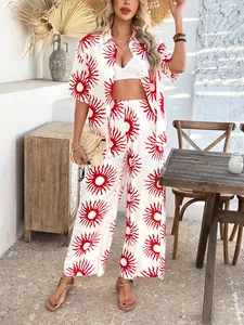Detail of bohemian two-piece set with red sunburst print and wide-leg pants for vacation