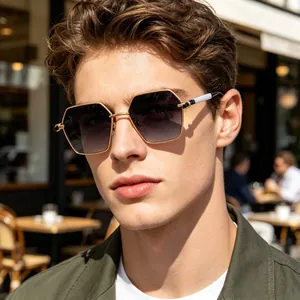 Detail of masculine gold hexagonal metal sunglasses with grey gradient lenses and dual-color arms