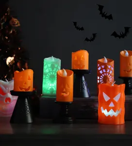 Close-up of LED Halloween lantern candles with pumpkin, spider web and skull motifs