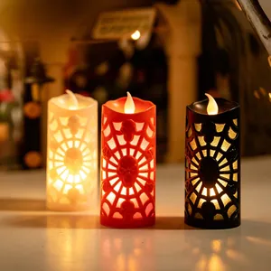 Close-up of Halloween LED candles with skull and spider web cutout patterns