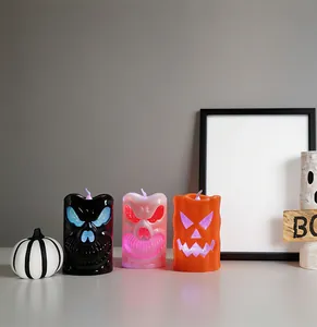 Close-up of Halloween LED candles with skull and pumpkin cutouts in multiple colors