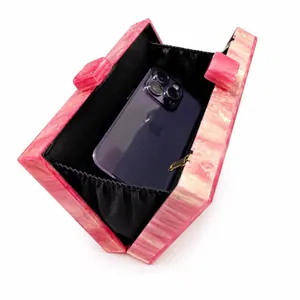 Pink marble acrylic evening clutch bag showing internal capacity for a smartphone