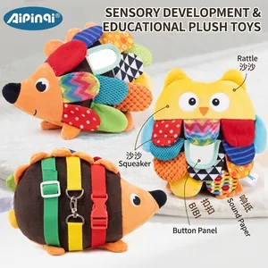 Detail of infant sensory plush toys featuring colorful labels and buckles for fine motor skills