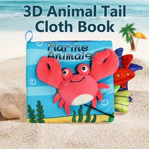 Close-up of baby fabric book with 3D marine animal tails and soft plush crab detail
