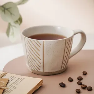 Japanese style hand-painted ceramic coffee mug with textured patterns and creamy white finish