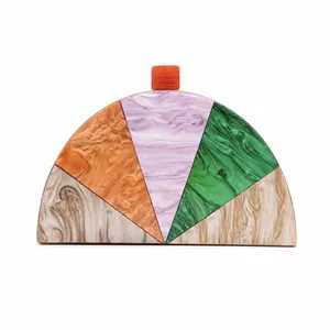 Detail of geometric acrylic semi-circle clutch bag with colorful marble patterns