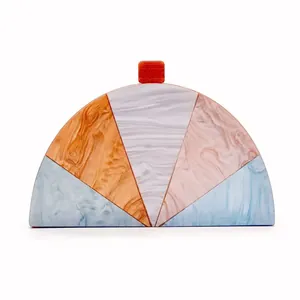 Semi-circular acrylic clutch with marble pattern and colorful block patchwork design