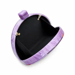 Detail showing the purple marble acrylic texture and gold metal clasp of the clutch bag