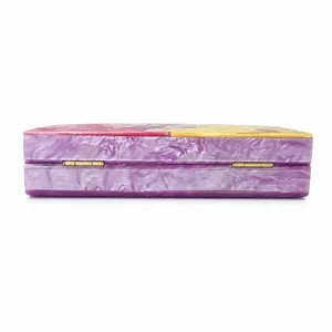 Detail of purple marble acrylic clutch bag with golden metal hinges and side panel joints