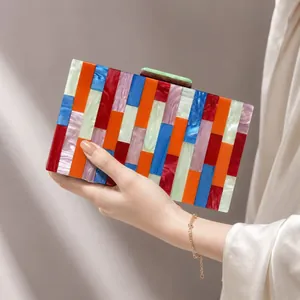Acrylic evening clutch with colorful striped marble texture and green magnetic clasp