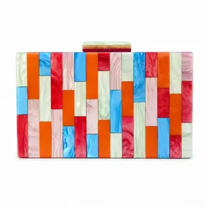 Detail view of colorful acrylic marble pattern patchwork on an evening clutch bag