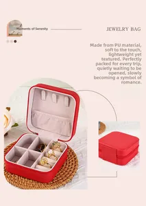 Detail of red PU leather jewelry box with velvet slots for rings and earrings