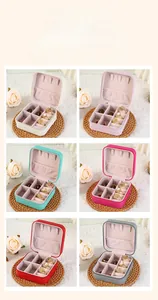 Detail view of multi-color leather jewelry boxes with ring slots and necklace hooks