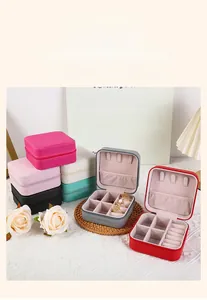 Close-up of portable PU leather jewelry boxes with zipper closure and velvet compartments