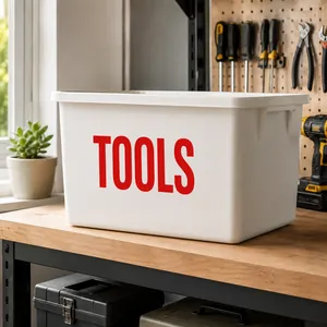 Close-up of white storage bin with red TOOLS text and integrated handles for garage use