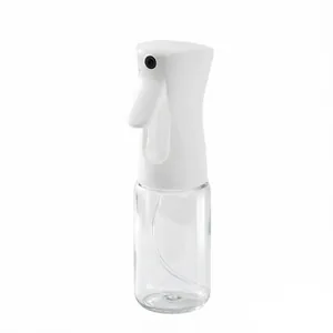 Detailed macro view of the fine mist nozzle and ergonomic handle on a clear oil sprayer bottle