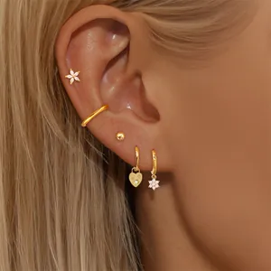 5pcs 24K gold plated earring set with zircon floral studs and cuffs on model's ear