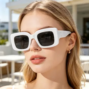 Close-up of stylish women sunglasses with thick white rectangular frames and dark lenses