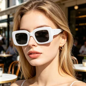 Close-up of stylish white rectangular sunglasses featuring deep grey polarized lenses