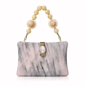 Elegant acrylic clutch with marble texture and round beaded handle for evening party wear
