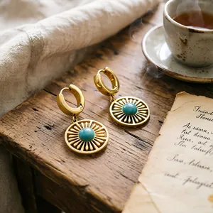 Vintage stainless steel earrings with turquoise stone and hollow sunburst pattern