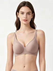 Detail of seamless deep V neck bra in nude beige with integrated soft jelly support