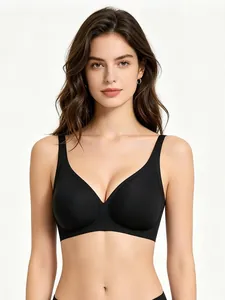 Seamless deep V-neck wireless black bra worn by a model on a light grey background